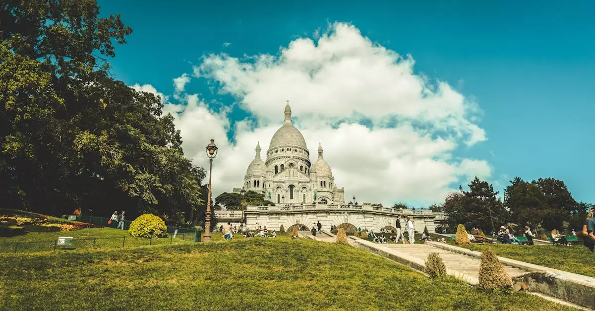 Stunning view of Sacre-Coeur Basilica with people enjoying the park on a sunny day.