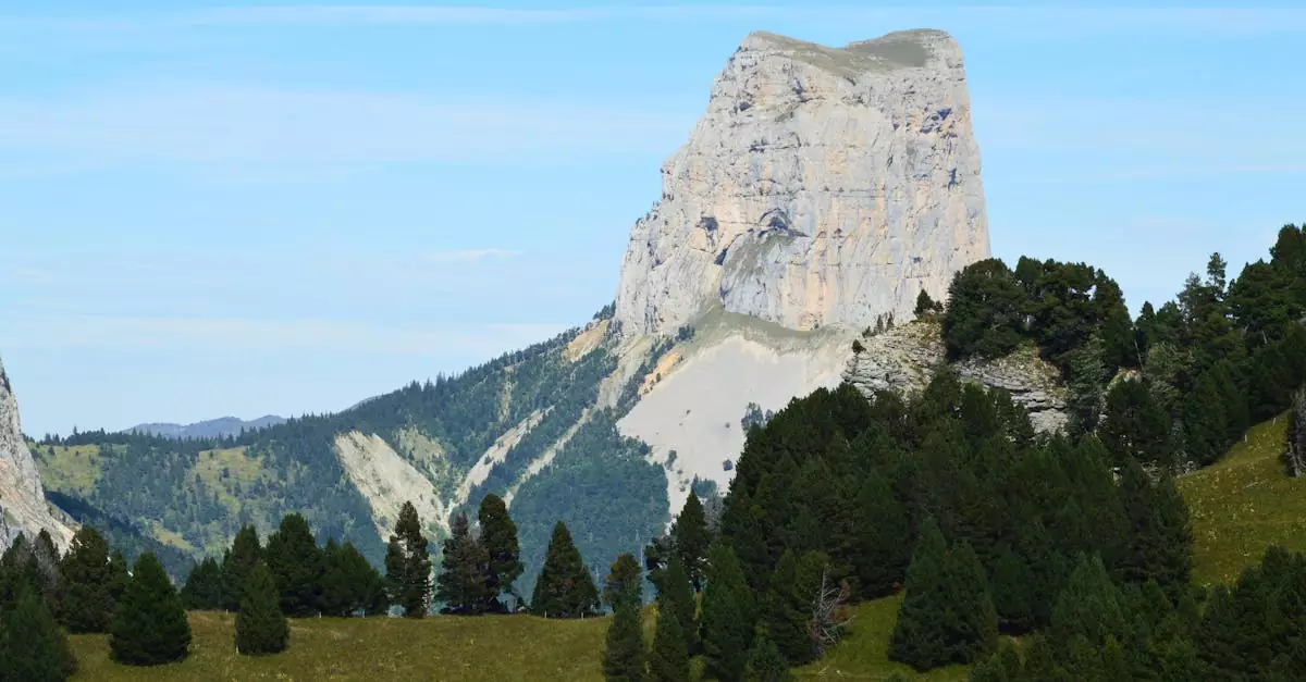 A breathtaking view of Mont Aiguille surrounded by lush greenery in Chichilianne, France.