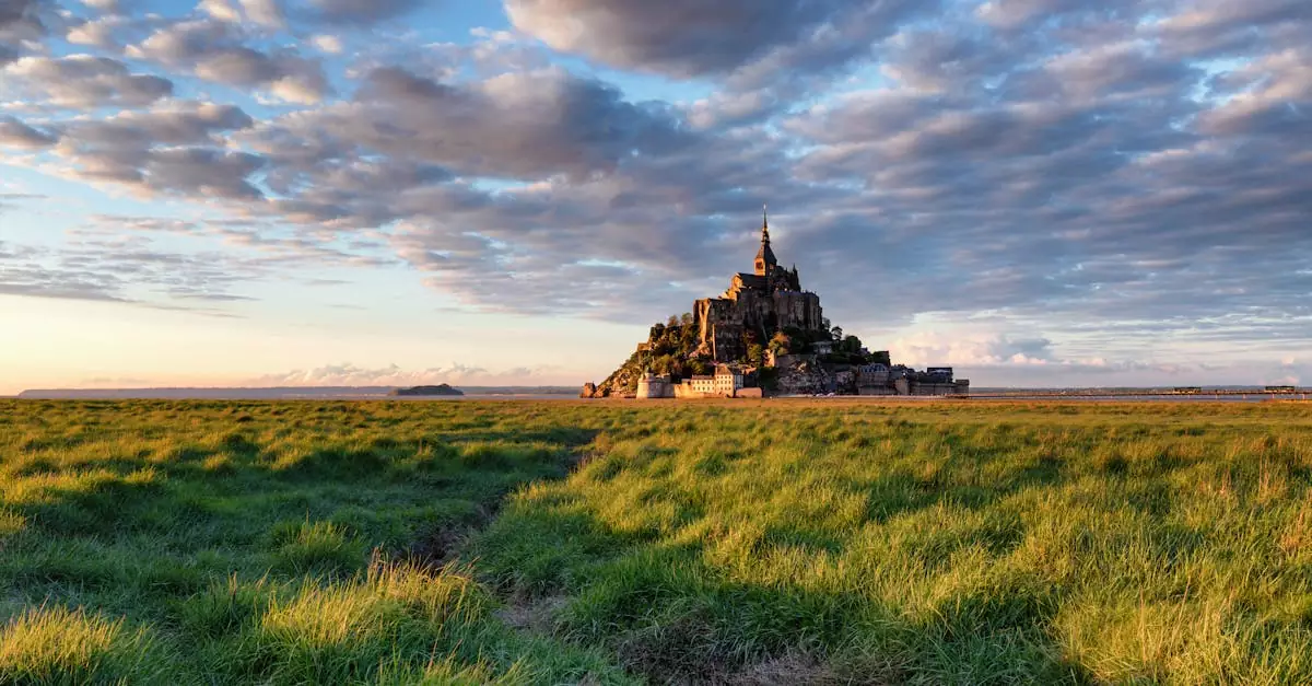 Capture of Mont Saint-Michel in Normandy during sunset over lush green fields.