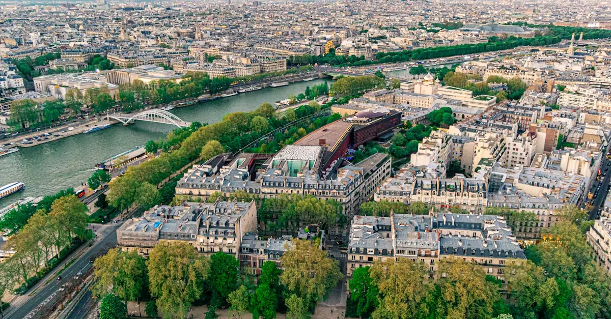 Stunning aerial view of Paris showcasing the Seine River and iconic architecture under a clear sky.
