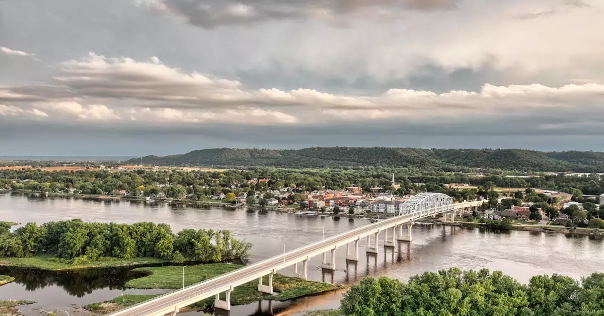 Aerial view of the Wabasha Bridge spanning the Mississippi River amidst lush greenery and cityscape.