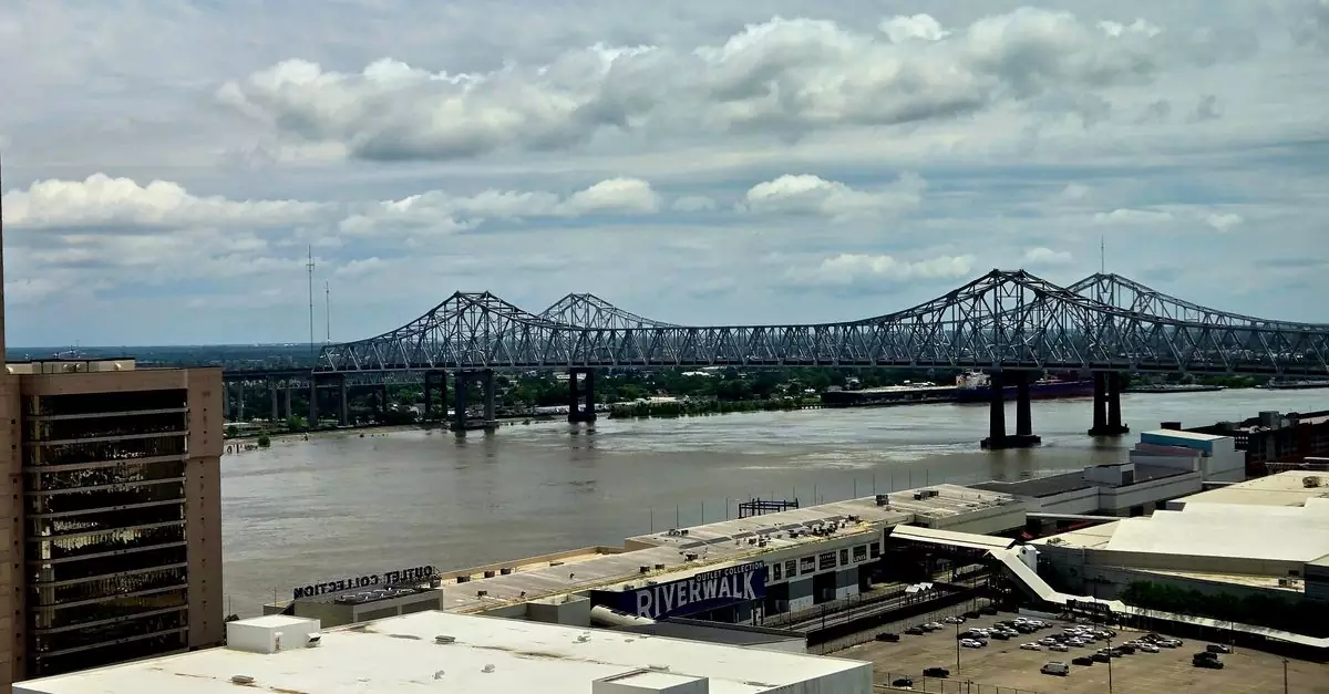 Stunning urban view of Mississippi River bridge from downtown area with cloudy sky.