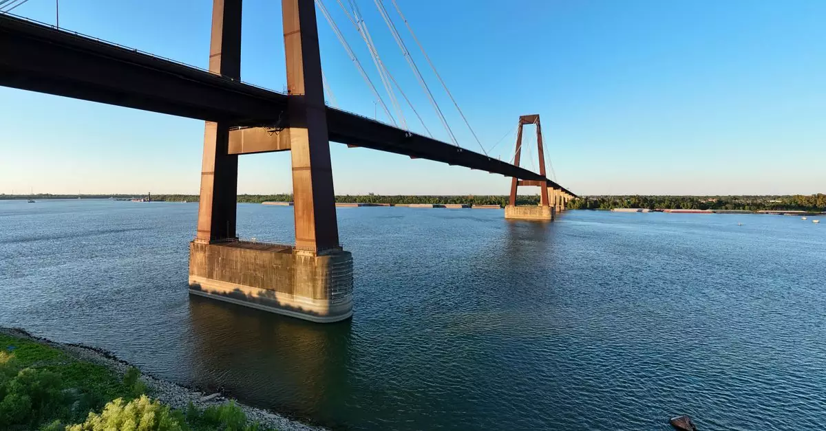 A stunning view of a suspension bridge across the Mississippi River in Louisiana at sunset, showcasing modern architecture.