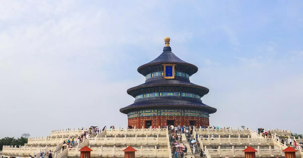 The iconic Temple of Heaven in Beijing, captured on a sunny day with vibrant crowds.