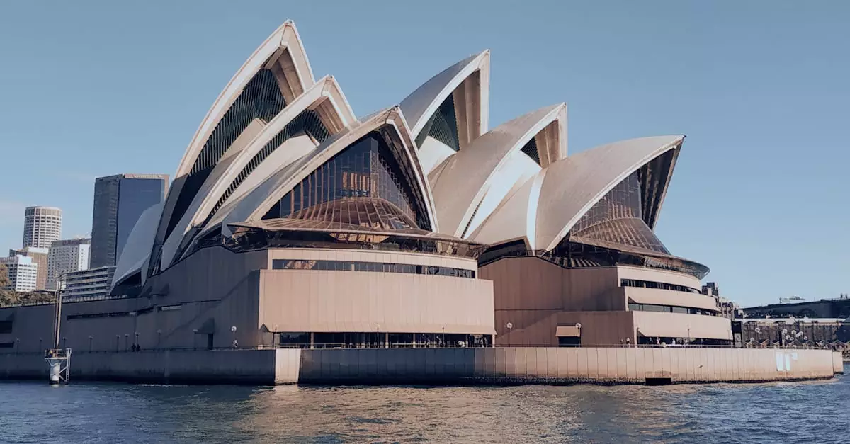 A stunning view of the iconic Sydney Opera House against a clear sky, reflecting its architectural marvel.