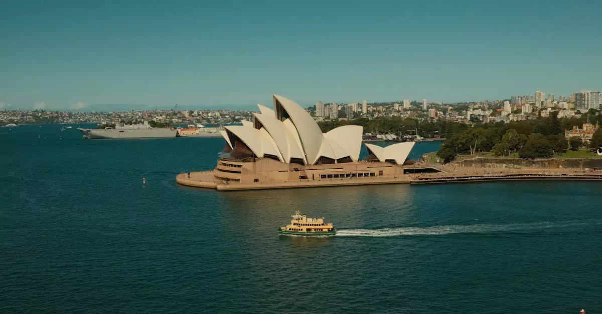A scenic view of Sydney Opera House with vibrant harbor activity and city skyline in the background.