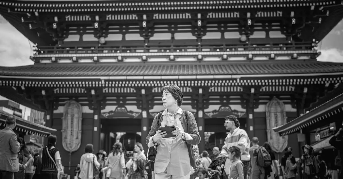 Black and white photo of people at Sensoji Temple in Tokyo, showcasing Japanese architecture.