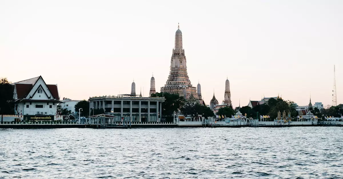 Beautiful view of Wat Arun Temple by the riverside in Bangkok at dusk.
