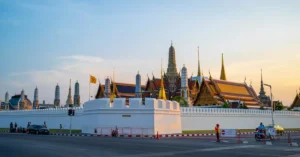 Stunning view of the Grand Palace in Bangkok with its traditional architecture during sunset.