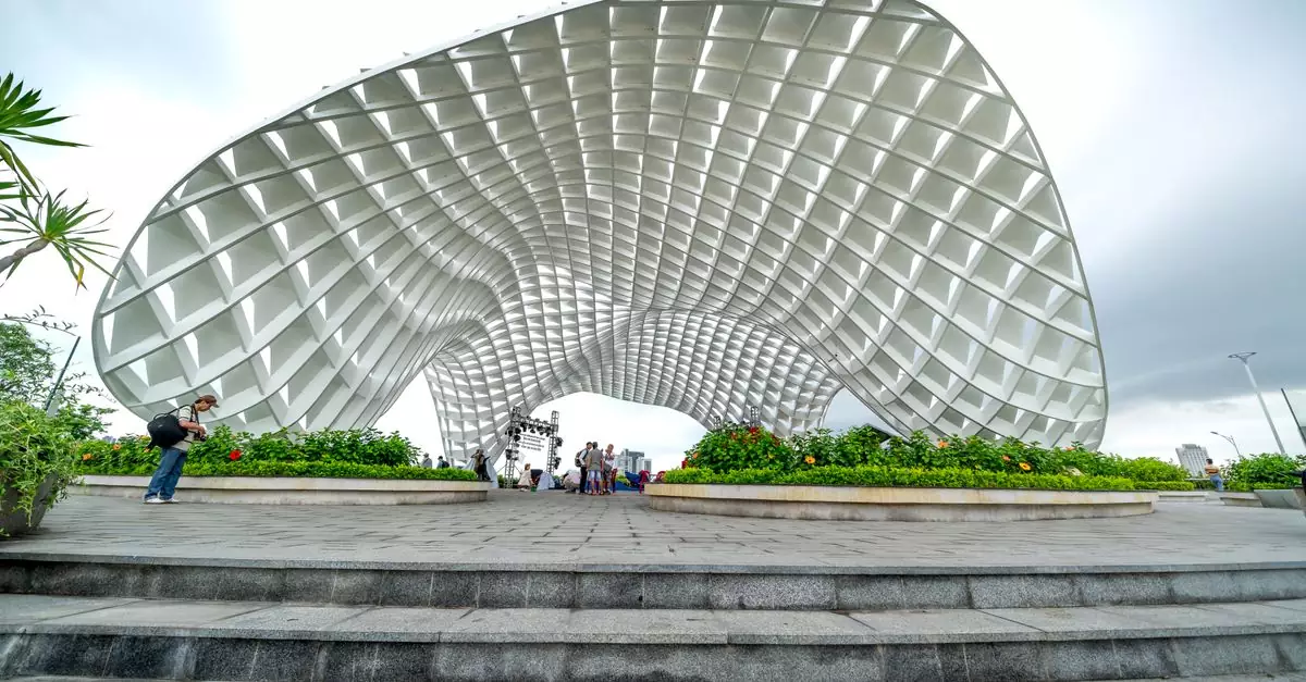 Photo of the iconic Apec Park landmark in Da Nang, Vietnam, featuring tourists and a cloudy sky.