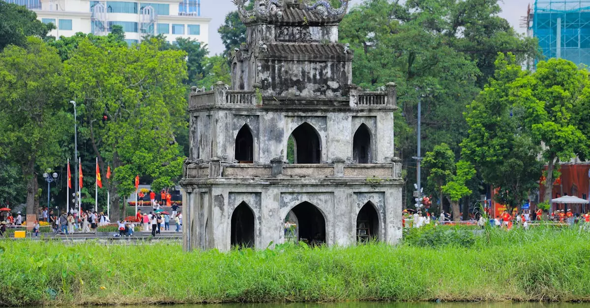 Historic Turtle Tower in Hoan Kiem Lake surrounded by lush greenery in Hanoi, Vietnam.