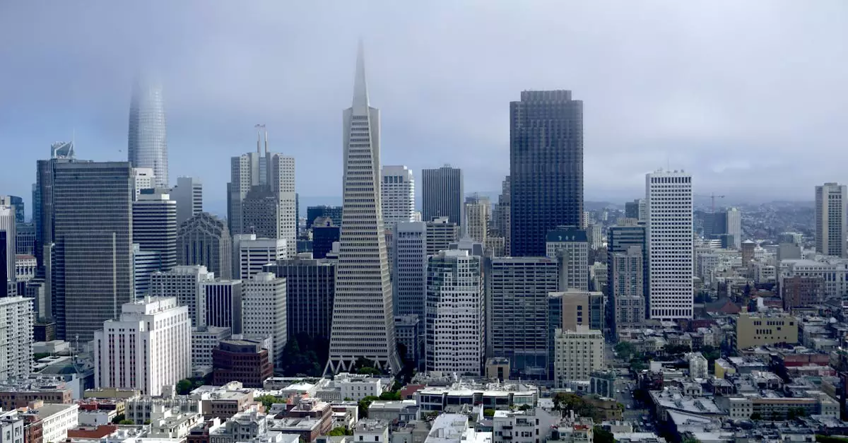 Panoramic aerial view of San Francisco's iconic skyline with fog and clouds.