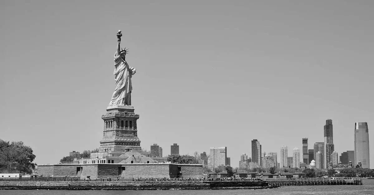 Black and white image of the Statue of Liberty with the New York City skyline.