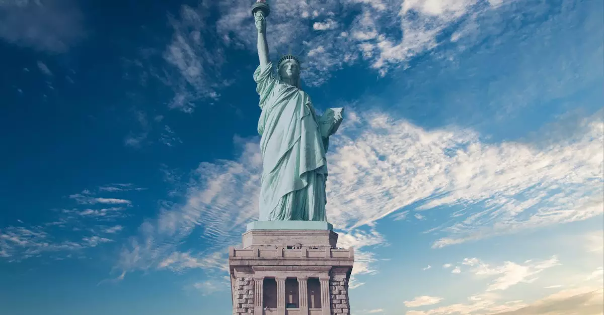 Iconic Statue of Liberty with a backdrop of a vibrant blue sky, symbolizing freedom and America.