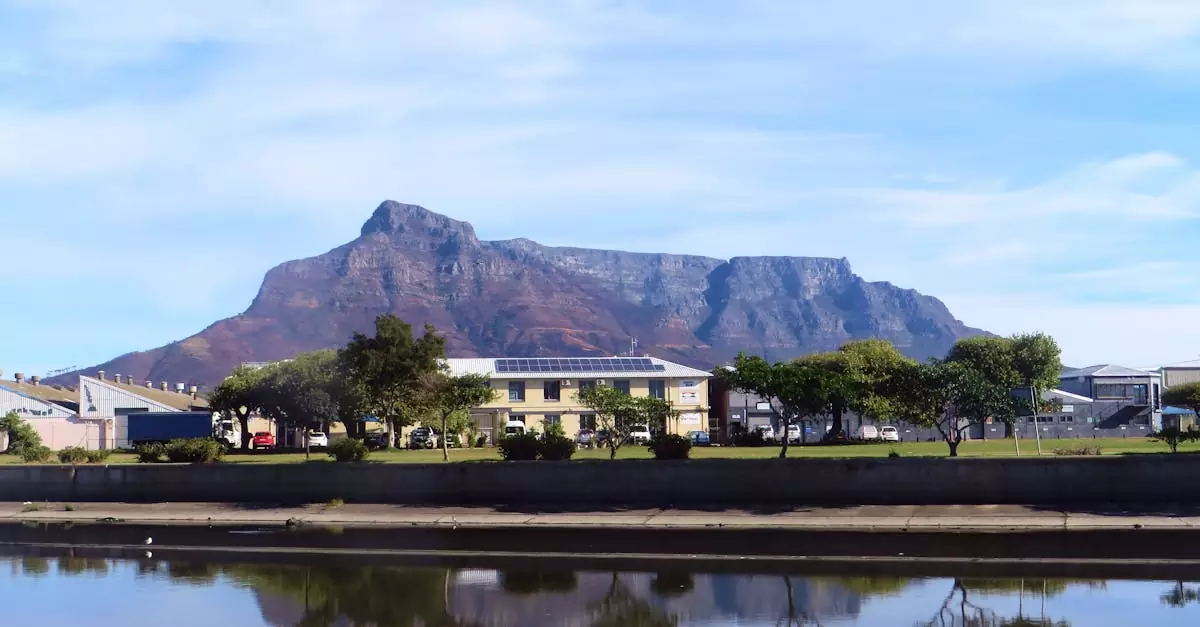 A picturesque view of Table Mountain with a reflection in the waters of Cape Town, South Africa.
