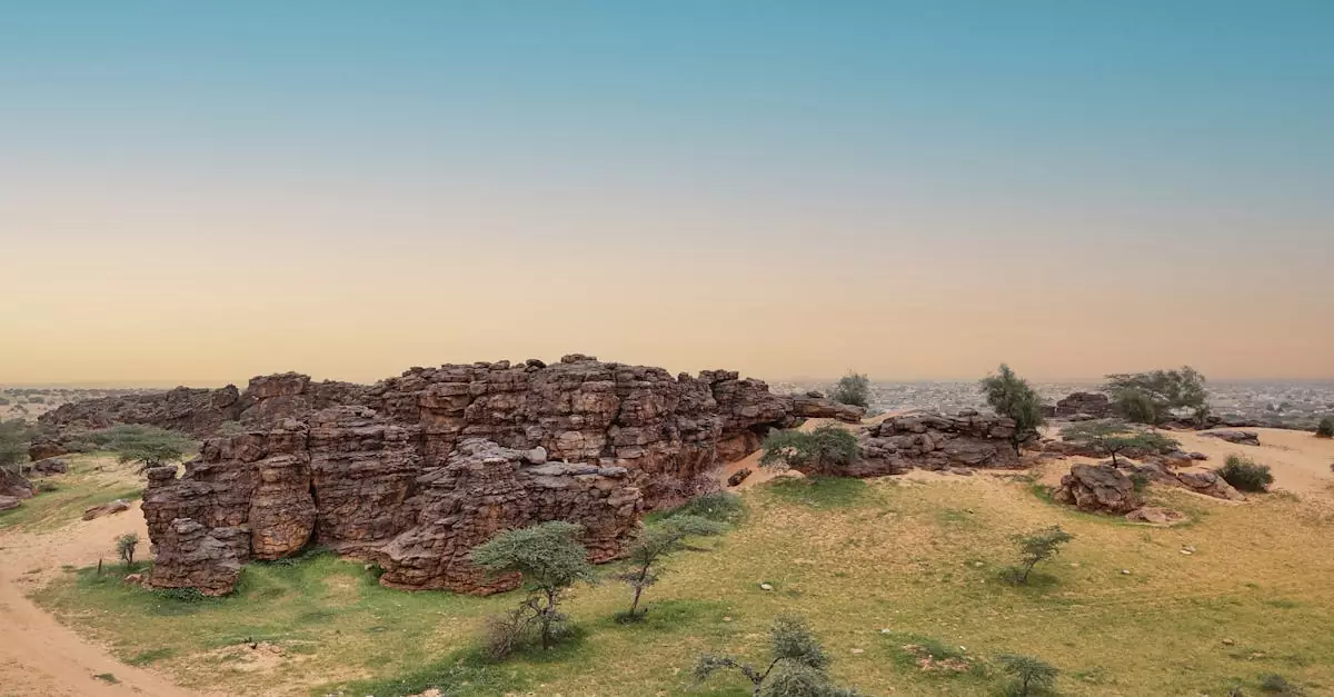 Explore the stunning rock formations and natural landscapes of Ayoun el Atrous in Mauritania at sunset.