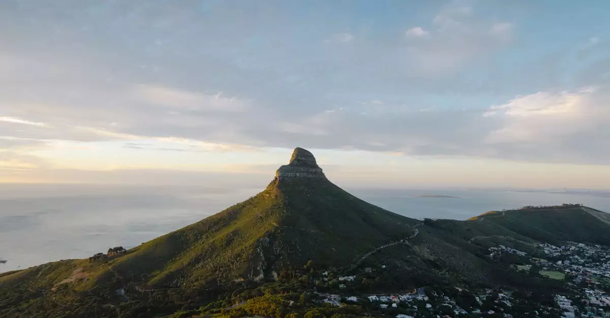 Capture of Lion's Head in Cape Town at sunset with ocean views.