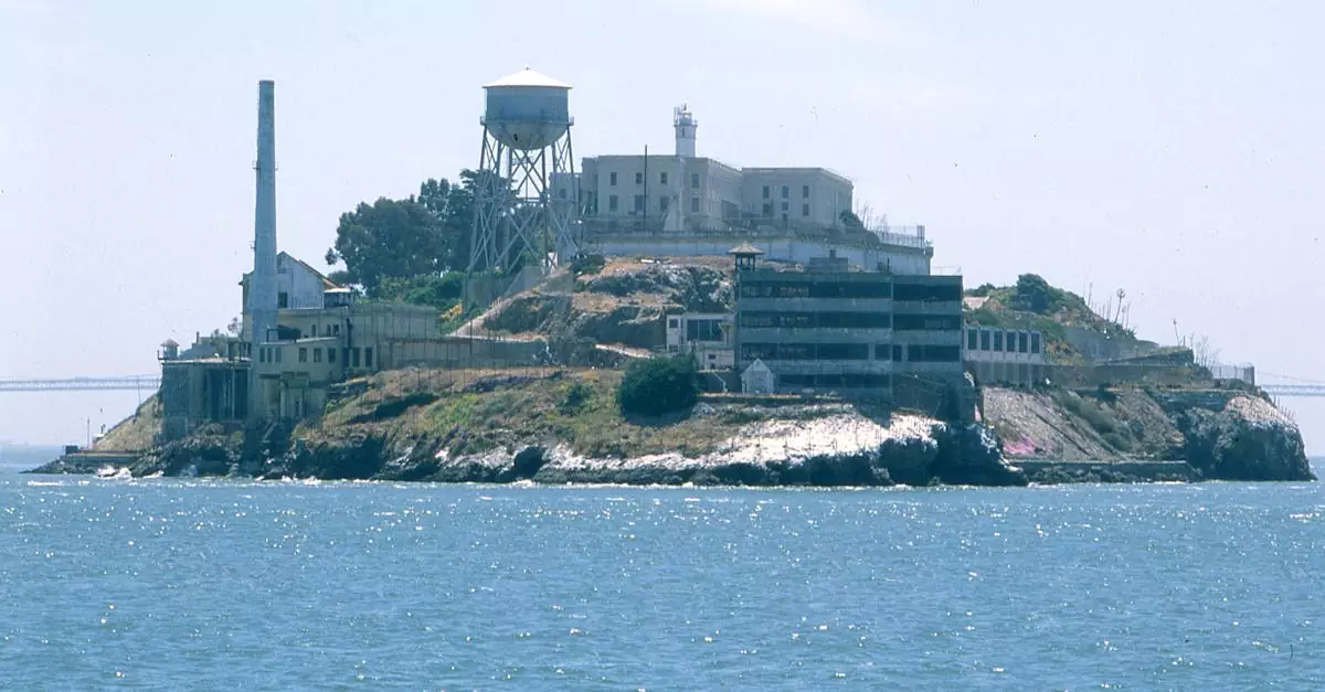View of Alcatraz Island with its famous prison, surrounded by blue waters.
