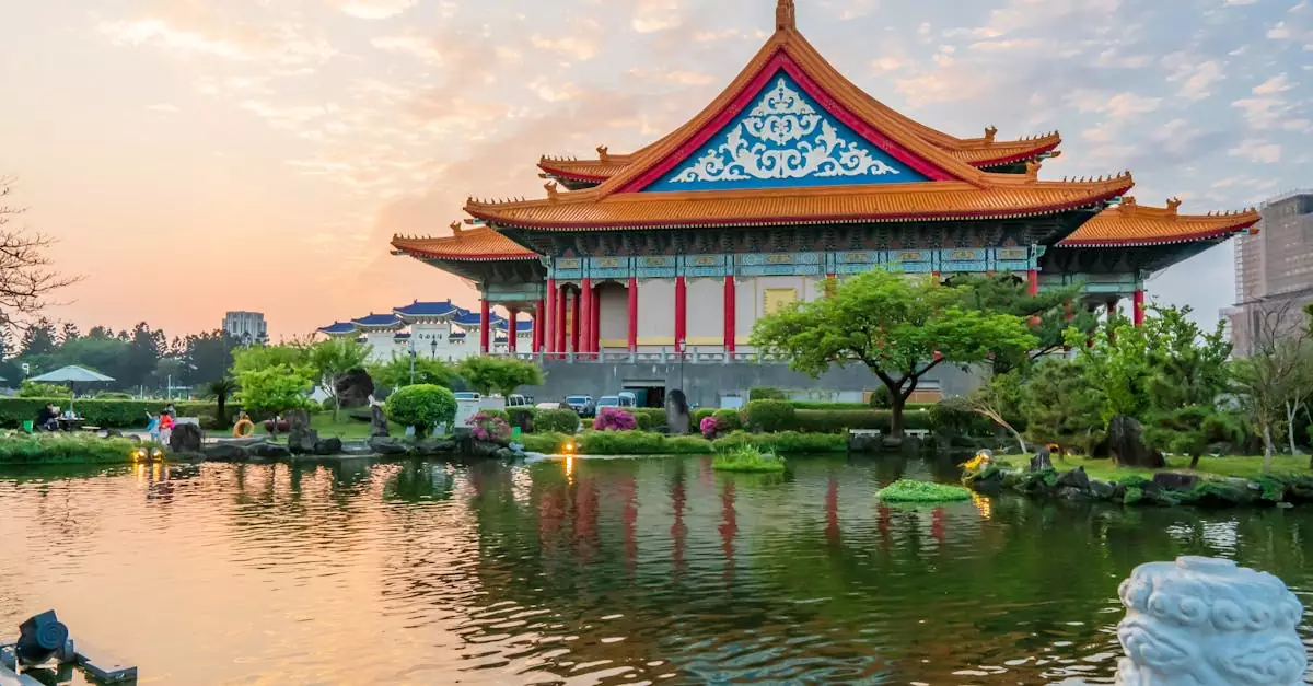 Captivating view of Taipei's National Theater with a tranquil pond during sunset.