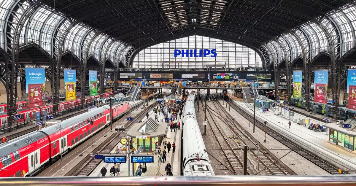Crowded central train station with multiple tracks and passengers, vibrant urban atmosphere.