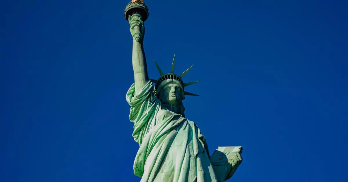Iconic Statue of Liberty with a majestic blue sky backdrop, symbol of freedom in New York City.