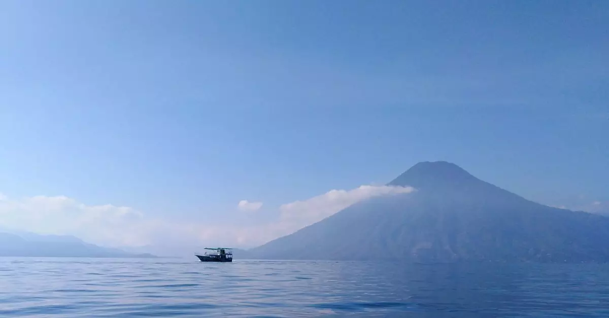 Tranquil view of Lake Atitlán and volcano surrounded by clear blue sky, Sololá, Guatemala.