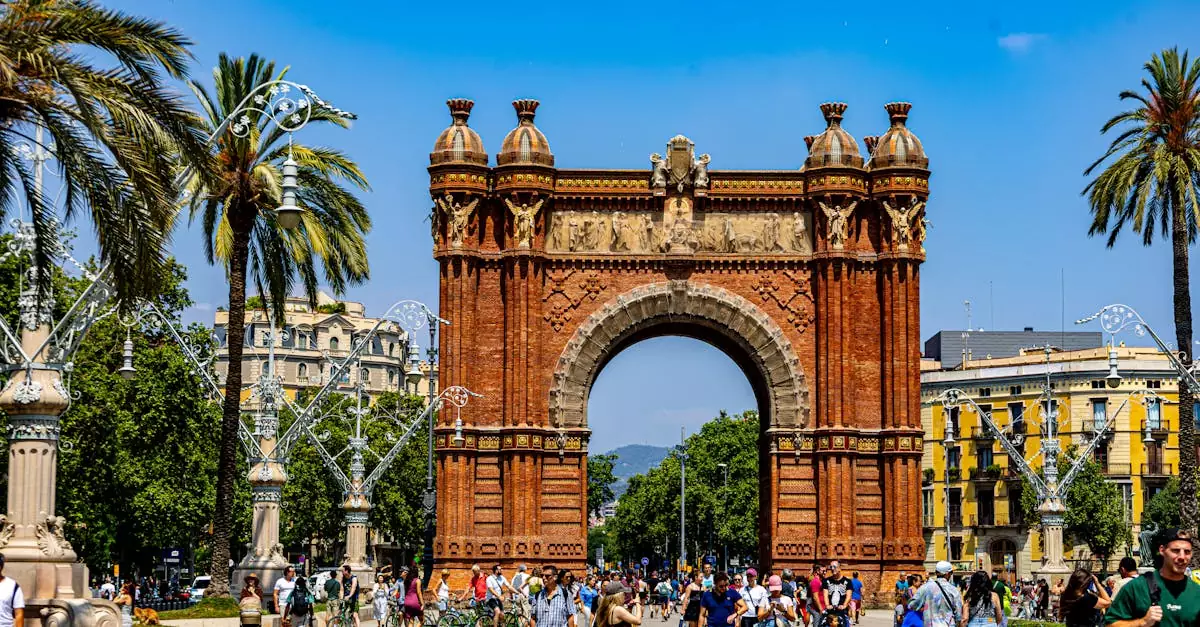 Vibrant summer scene at Arc de Triomf with tourists enjoying the day in Barcelona, Spain.