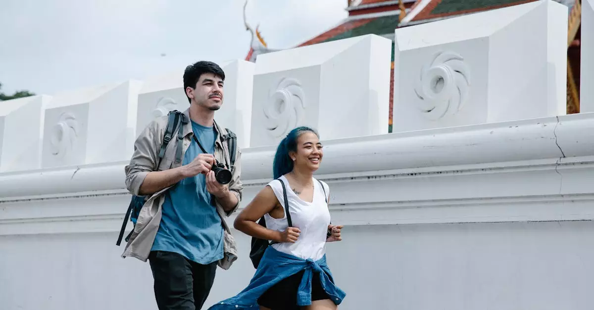 A cheerful couple exploring an outdoor landmark with traditional architecture.