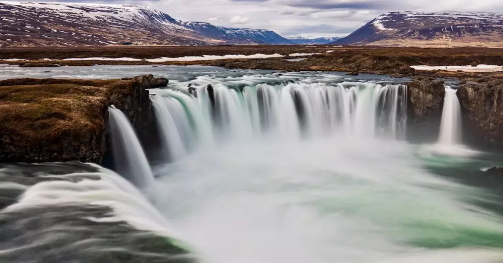 Capture the awe of Godafoss waterfall in Iceland's stunning landscape, a favorite travel destination.