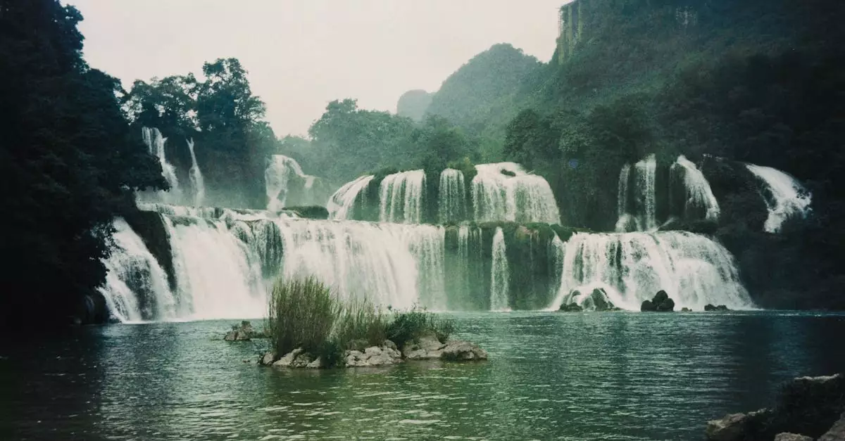 Explore the breathtaking Ban Gioc Waterfalls cascading through lush greenery in Cao Bang, Vietnam.