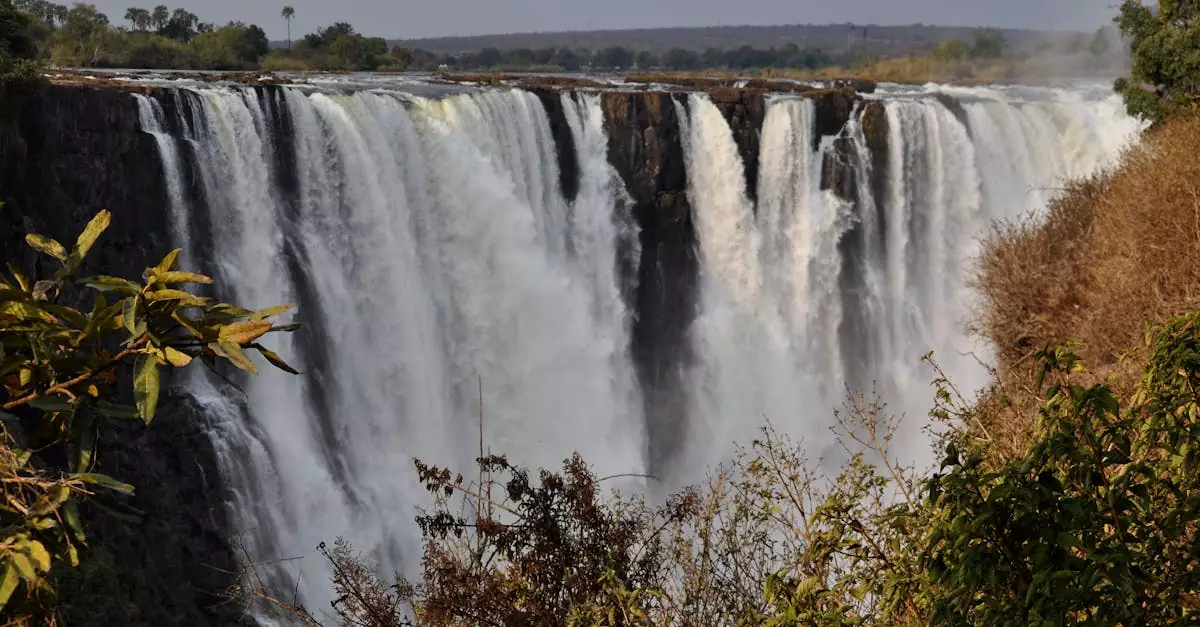 Spectacular view of Victoria Falls cascading in Zimbabwe, showcasing natural beauty and power.
