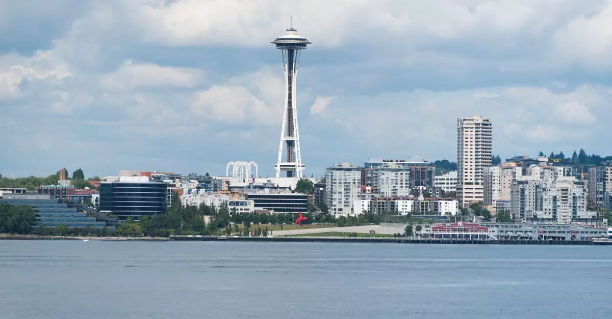 A scenic view of the Seattle skyline featuring the iconic Space Needle against a cloudy sky.