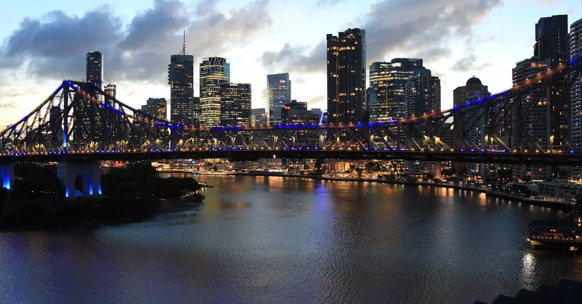 Capture of Brisbane's skyline with the illuminated Story Bridge, reflecting over the river at twilight.