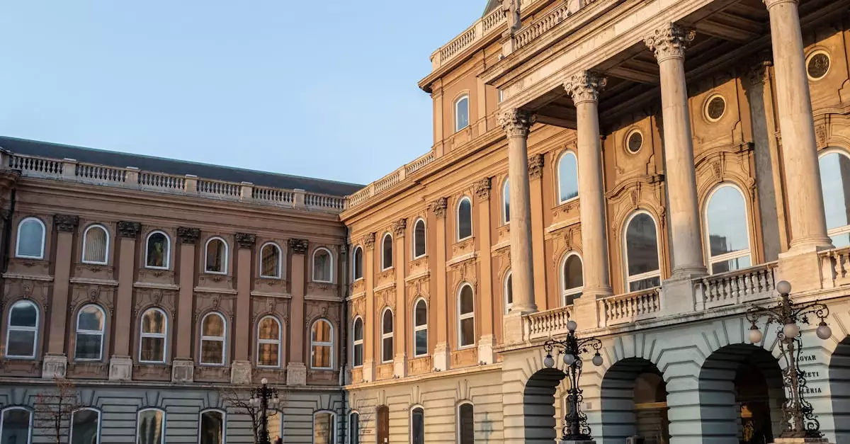 Elegant architecture of Buda Castle's courtyard, highlighting historical windows and arches.
