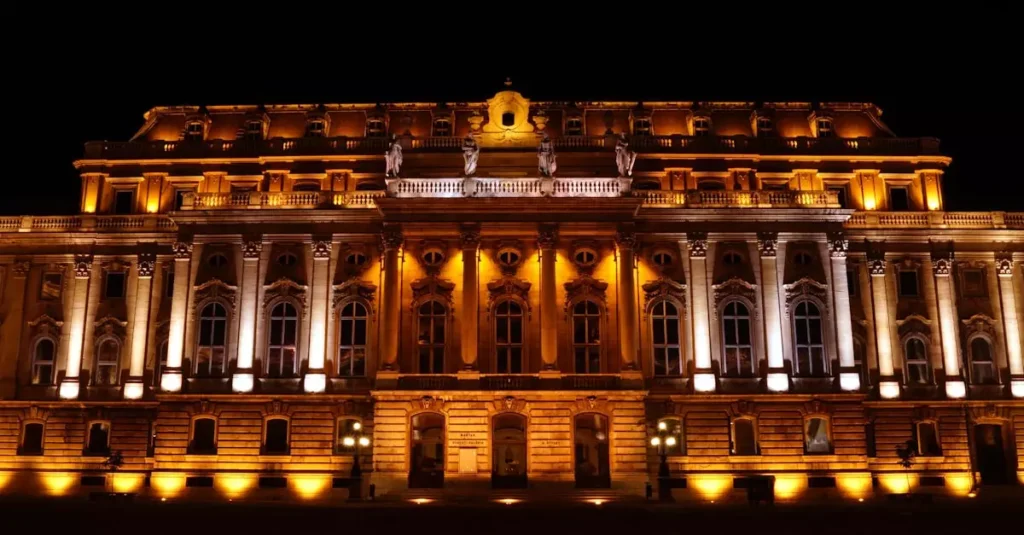 Night view of the beautifully illuminated Buda Castle, an iconic landmark in Budapest, Hungary.
