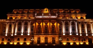 Night view of the beautifully illuminated Buda Castle, an iconic landmark in Budapest, Hungary.