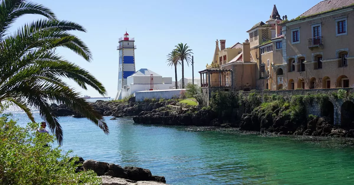 Picturesque coastal view featuring Santa Marta Lighthouse, palm trees, and charming architecture in Lisbon.