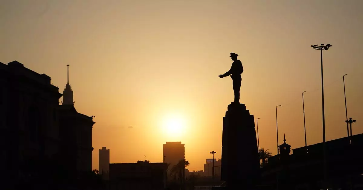 Silhouette of a landmark statue in Cairo during a vibrant sunset, creating a dramatic skyline.