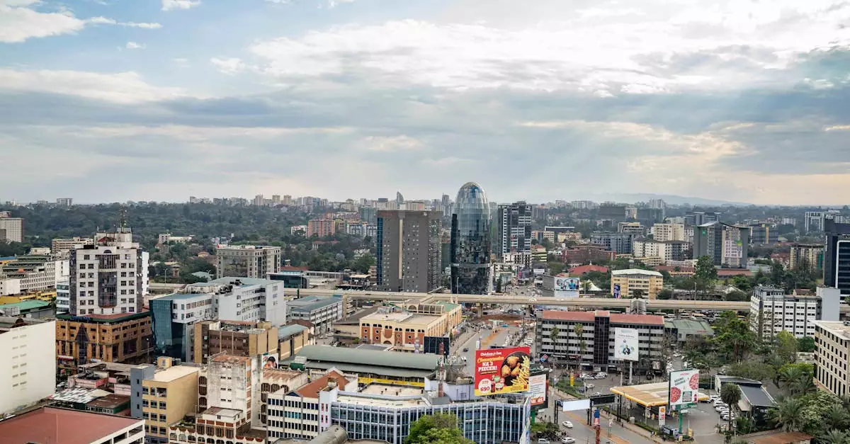 A vibrant aerial shot of Nairobi's bustling cityscape with modern architecture under a partly cloudy sky.
