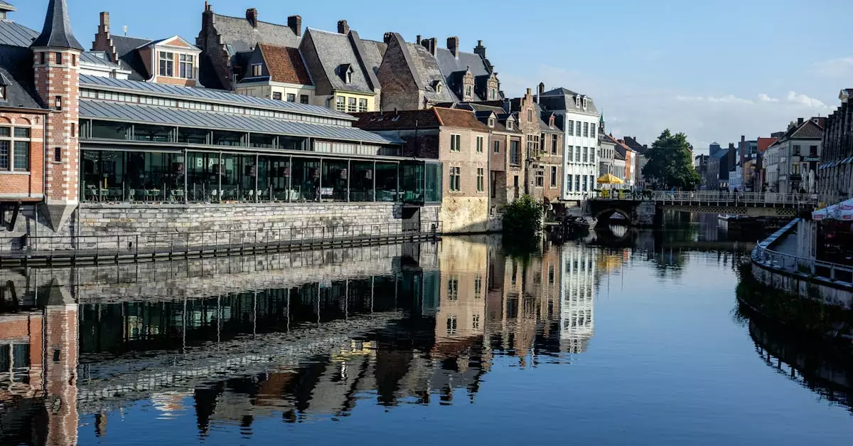 Reflection of historic buildings along the canal in Ghent, Belgium's Graslei quay.