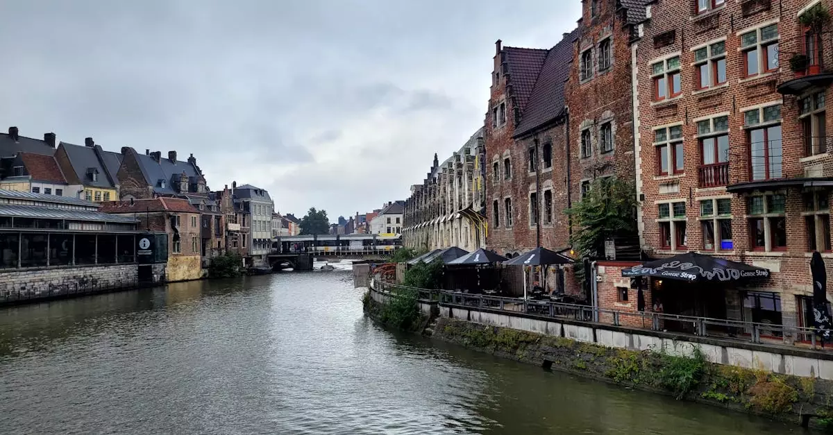 Charming view of historic canal and traditional buildings in Ghent, Belgium. Ideal travel shot.