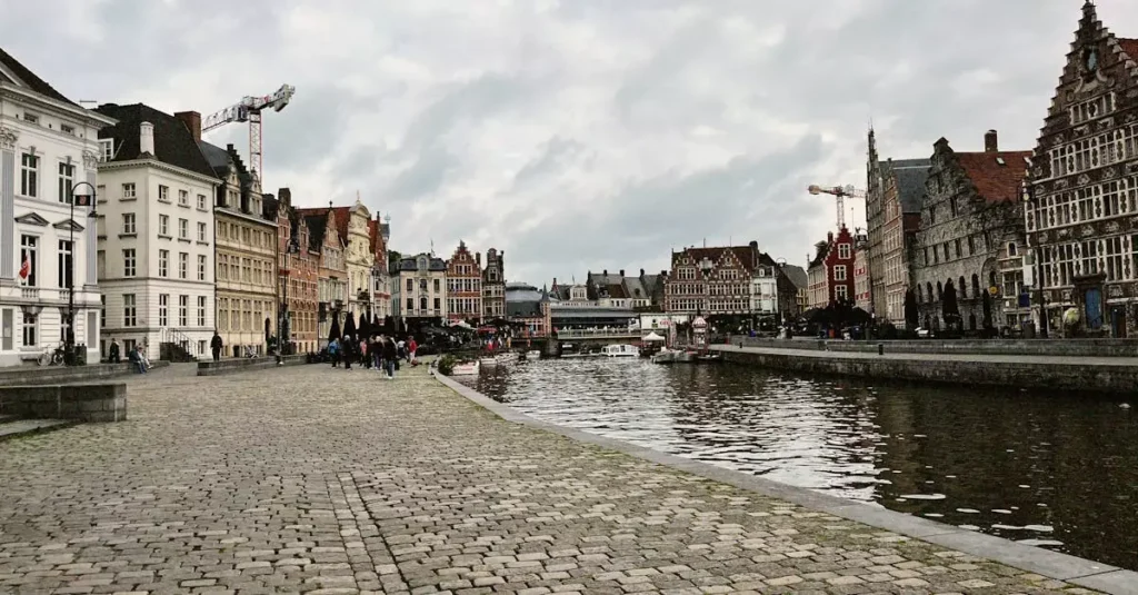 Explore Ghent, Belgium with its stunning medieval architecture and serene canal scene.