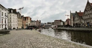 Explore Ghent, Belgium with its stunning medieval architecture and serene canal scene.