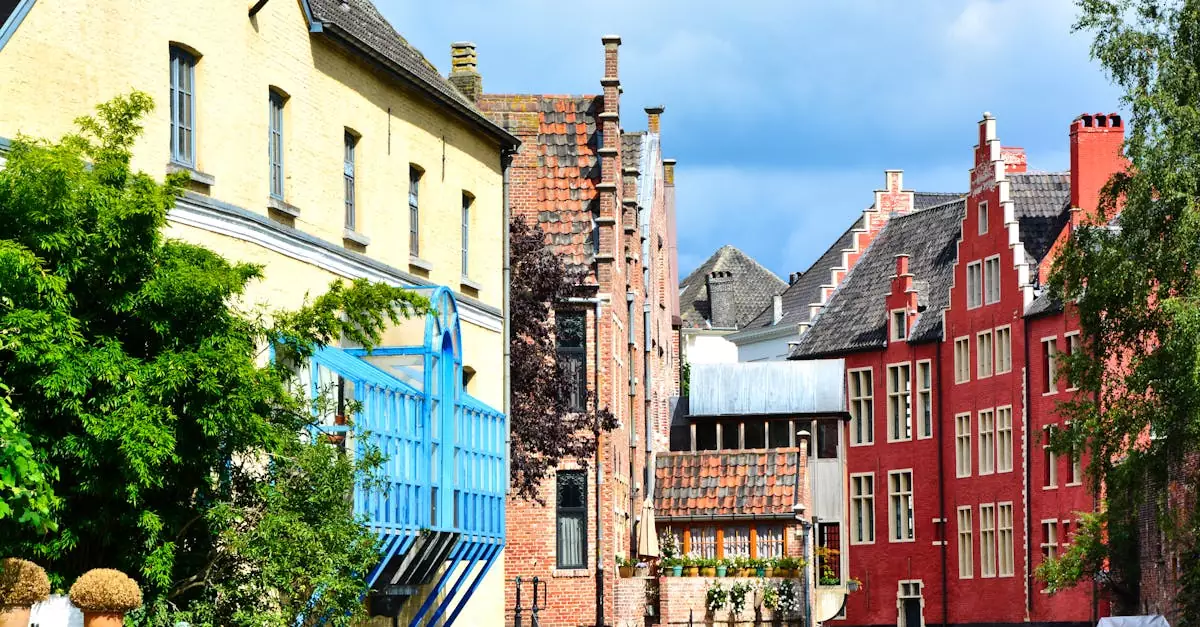 Charming canal houses with colorful facades in Ghent, Flanders, reflecting vibrant architecture.