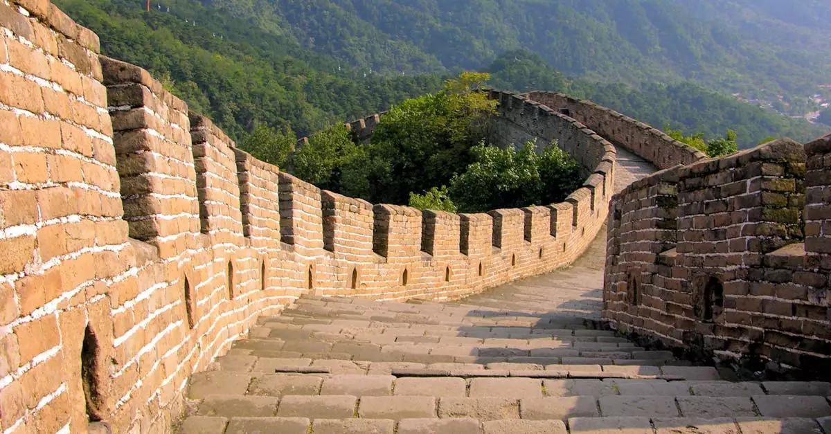 Scenic view of the Great Wall of China winding through lush green mountains.