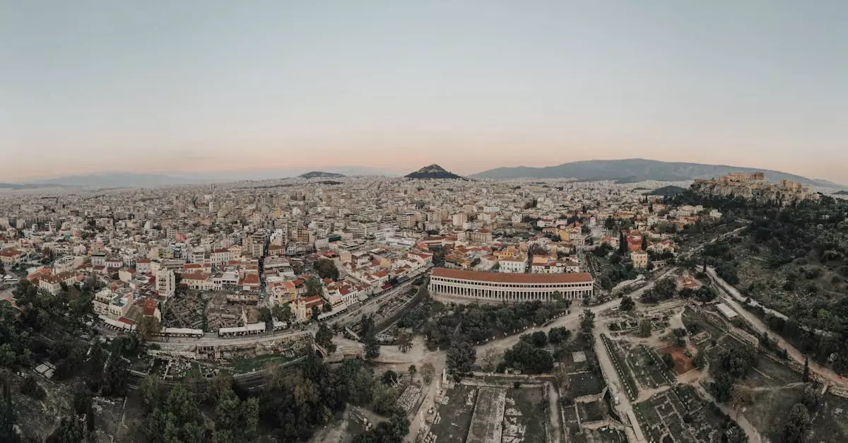 A stunning aerial view of Athens cityscape at sunrise, showcasing historical landmarks.