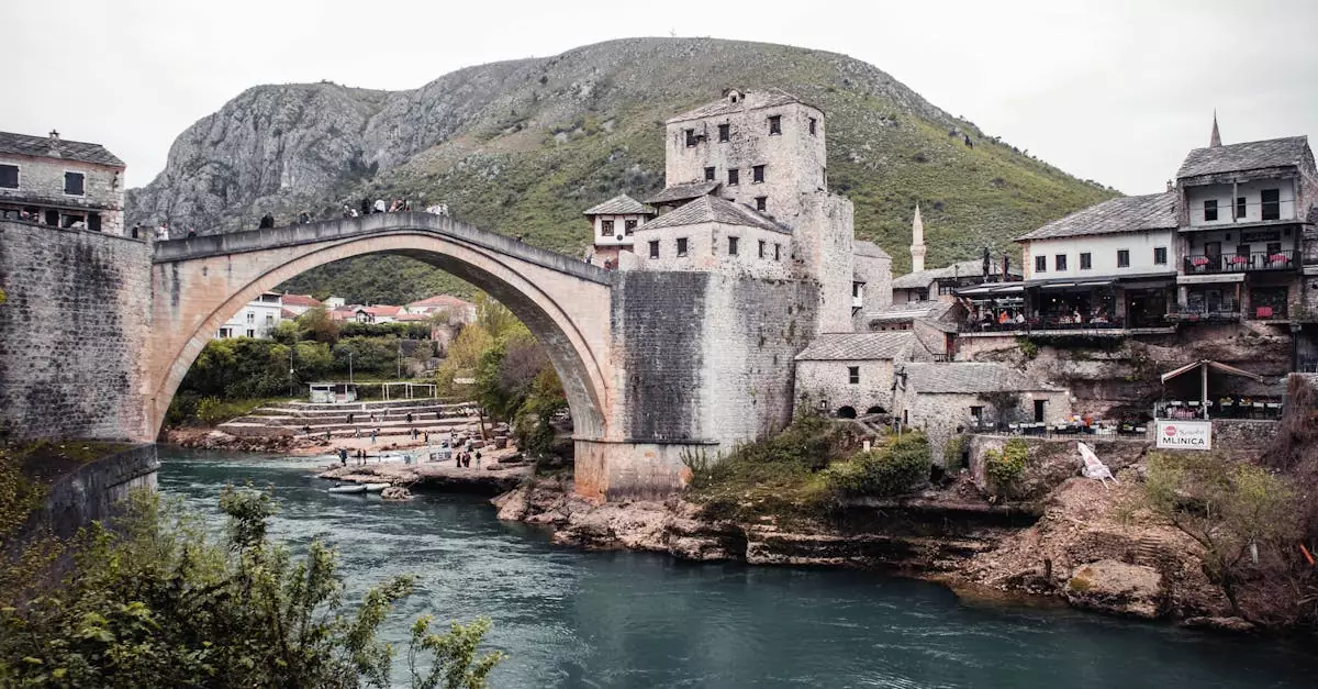 Explore the historic Stari Most bridge in Mostar, Bosnia, overlooking the scenic Neretva River.