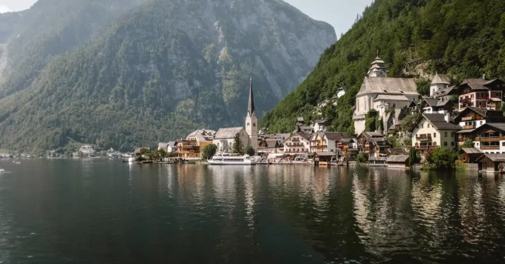 Serene view of Hallstatt village nestled by the lake, with mountains in the background.