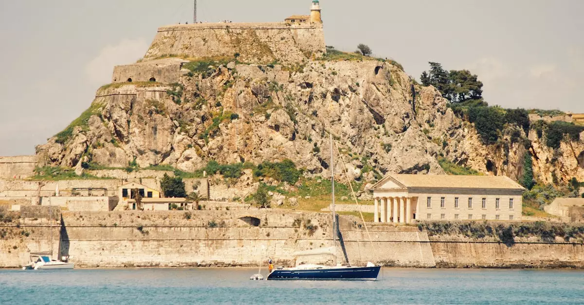 View of the historic Old Fortress in Corfu, Greece, with a sailing boat in the foreground.