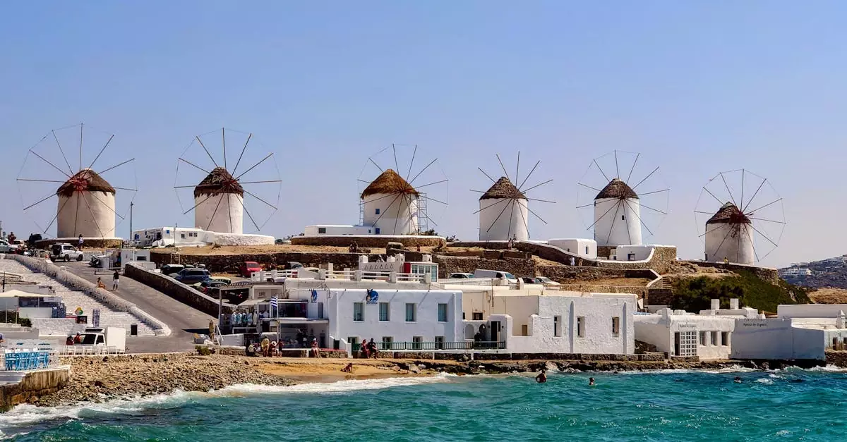 A scenic view of the historic Mykonos windmills against the azure Aegean Sea.